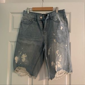 Distressed style jean cut off shorts, Bermuda length.